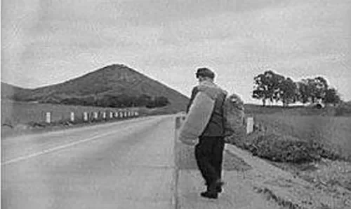 Hobo with bedroll on the highway