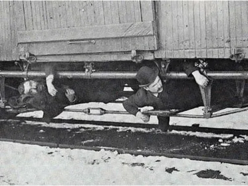 Two hobos under a boxcar, 1894