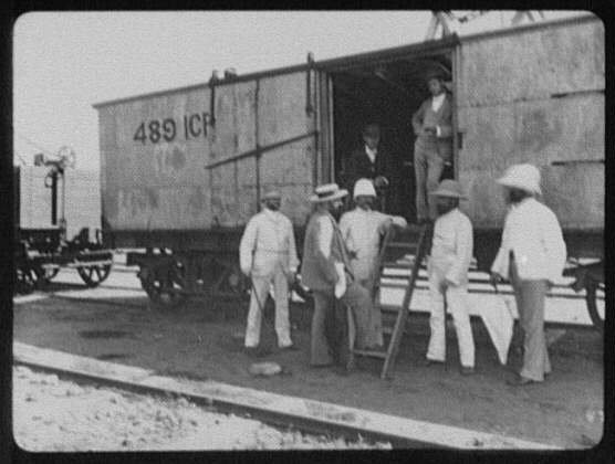 Seven men at door of freight car