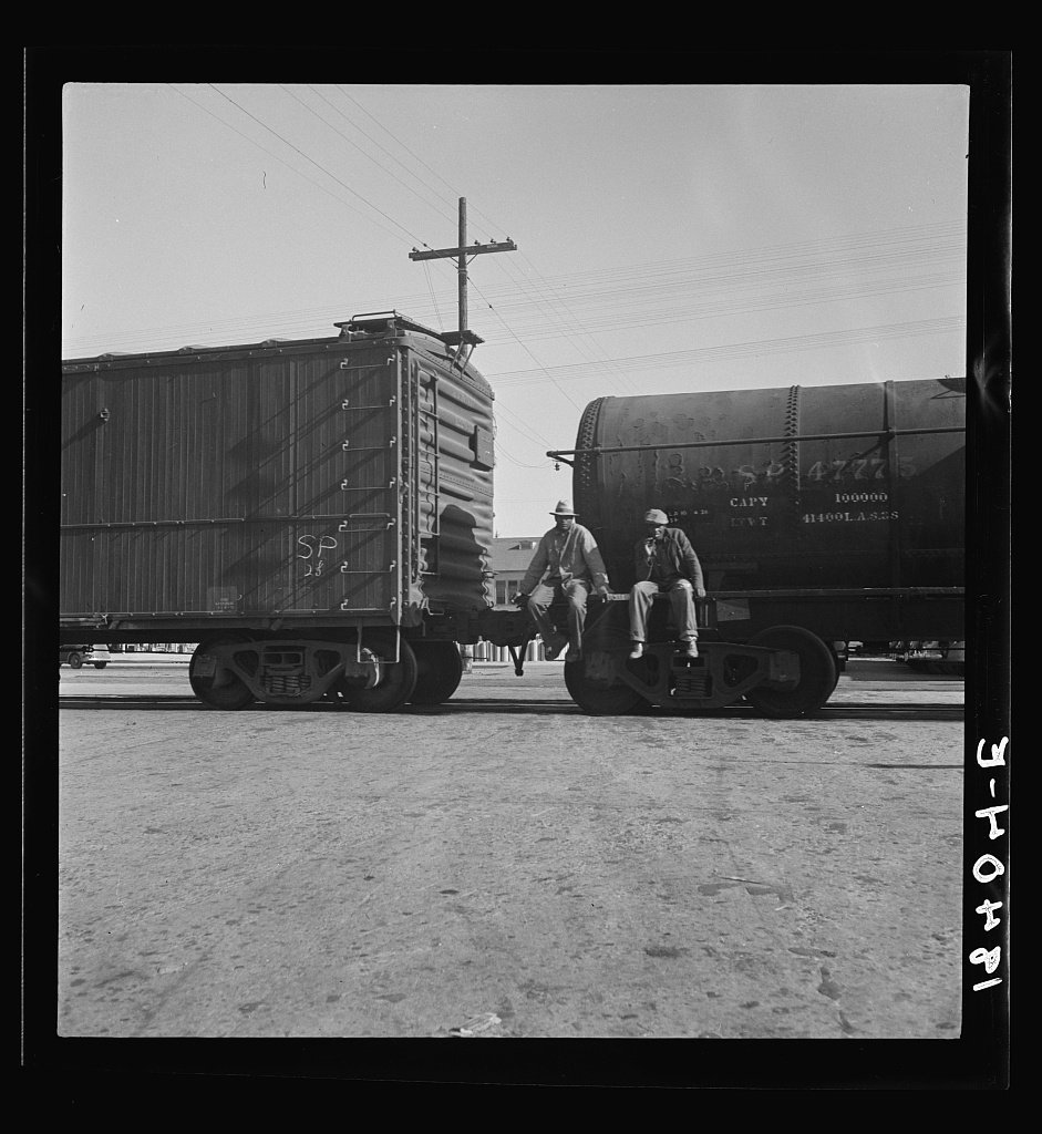 Colored itinerants on oil tank cars passing through Kingsbury, California