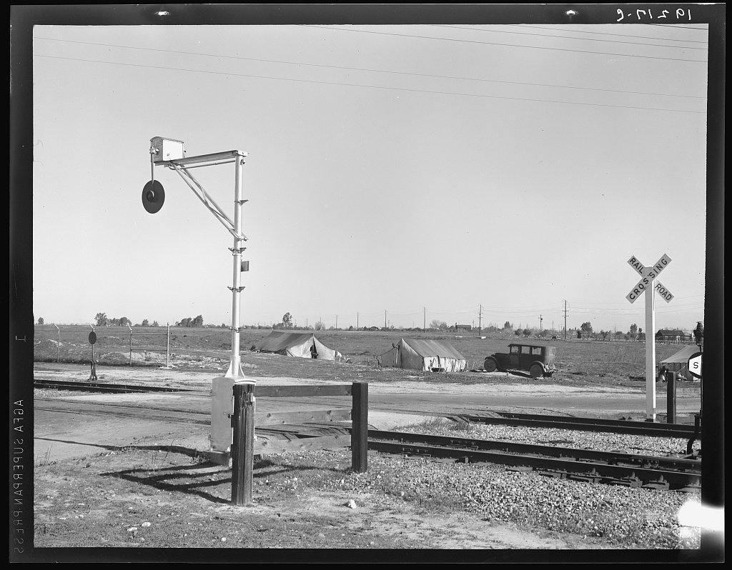 Migrants' tents are a common sight along the right of way of the Southern Pacific. Near Fresno, California